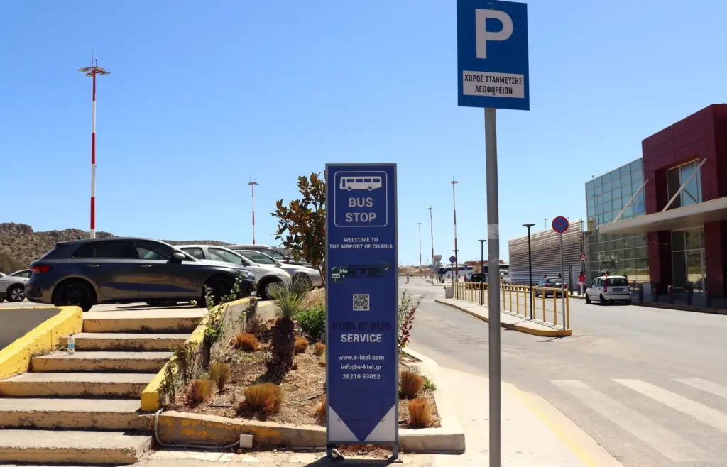 Bus stop at Chania International Airport (CHQ) with KTEL Crete sign and timetable, August 2025