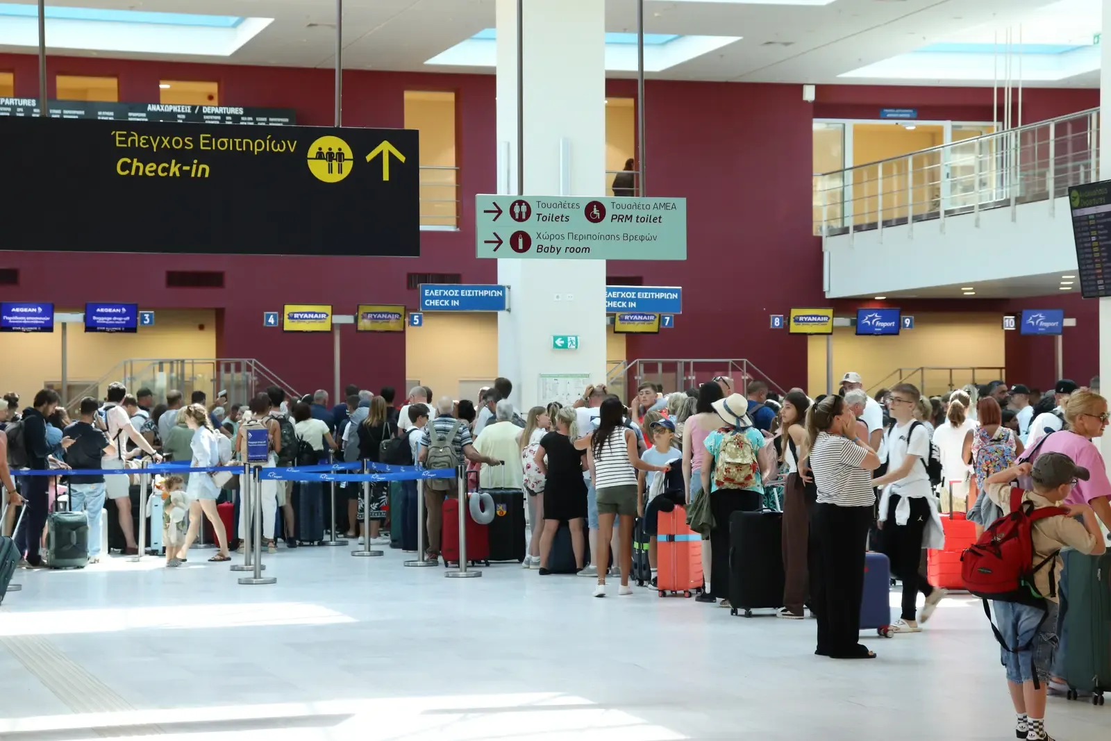 Check-in area at Chania International Airport (CHQ) with travelers waiting in line