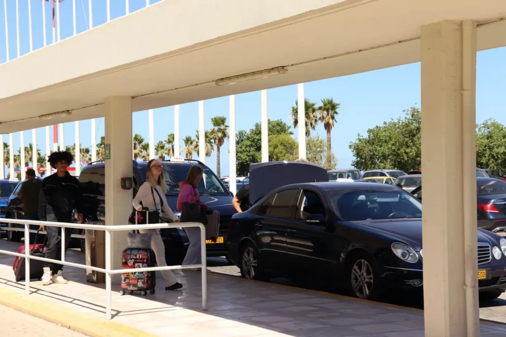 Travelers waiting for a taxi outside Chania International Airport (CHQ), Crete