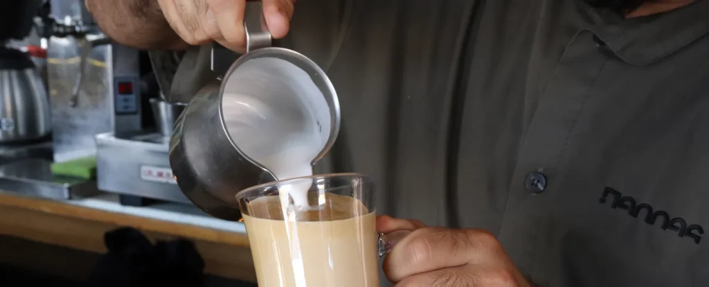 Barista preparing coffee at Pallas Restaurant in Chania