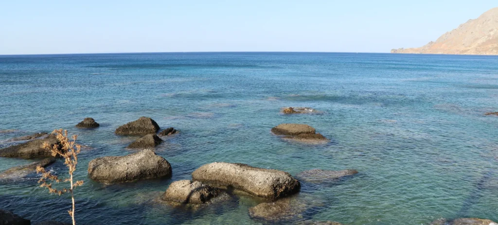 Glyka Nera (Sweet Water Beach) — view of the calm turquoise waters and rocky coastline, photo by Zurab Peikrishvili / CreteTales