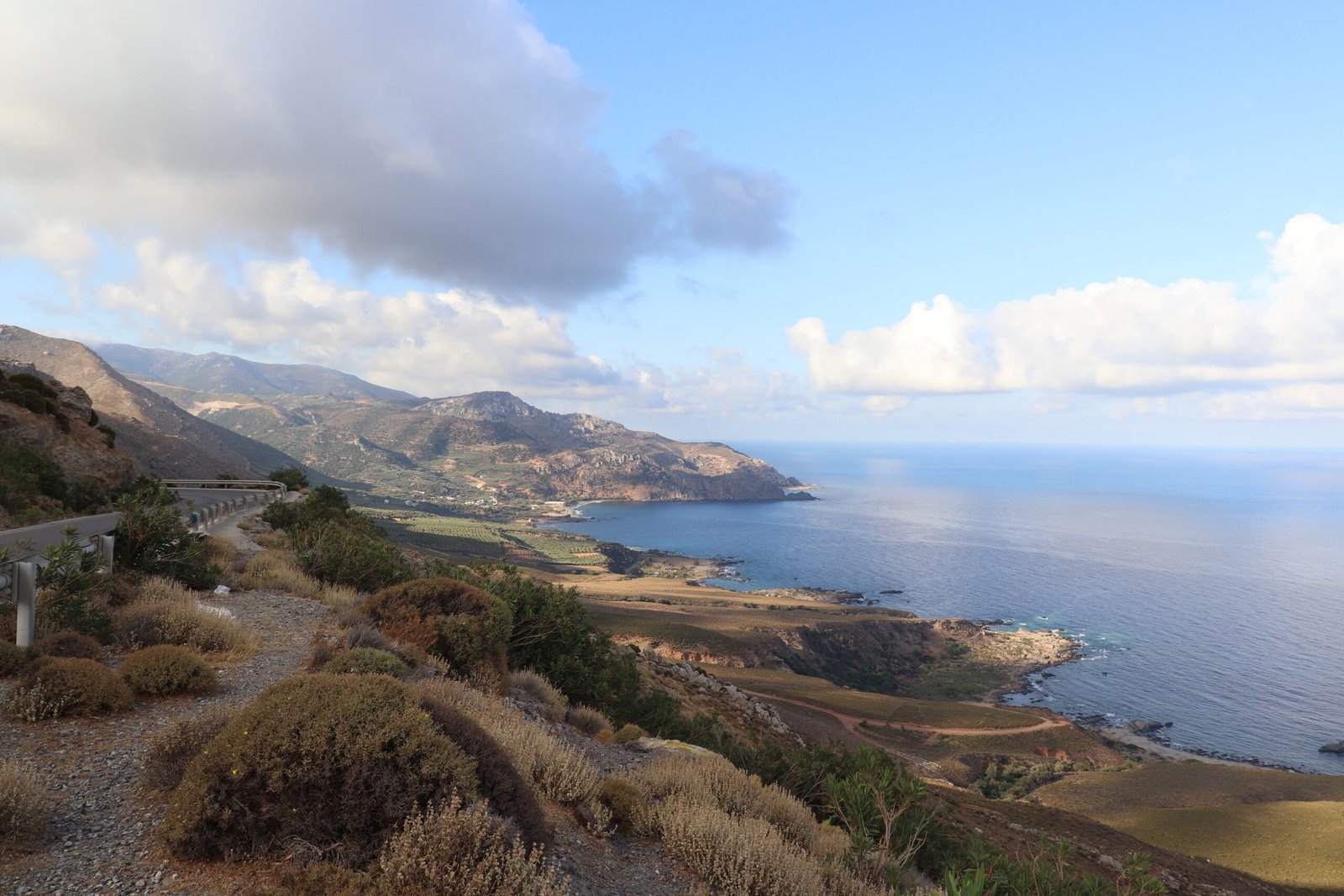 View of Sfinari Bay from the road with the coastline and hills