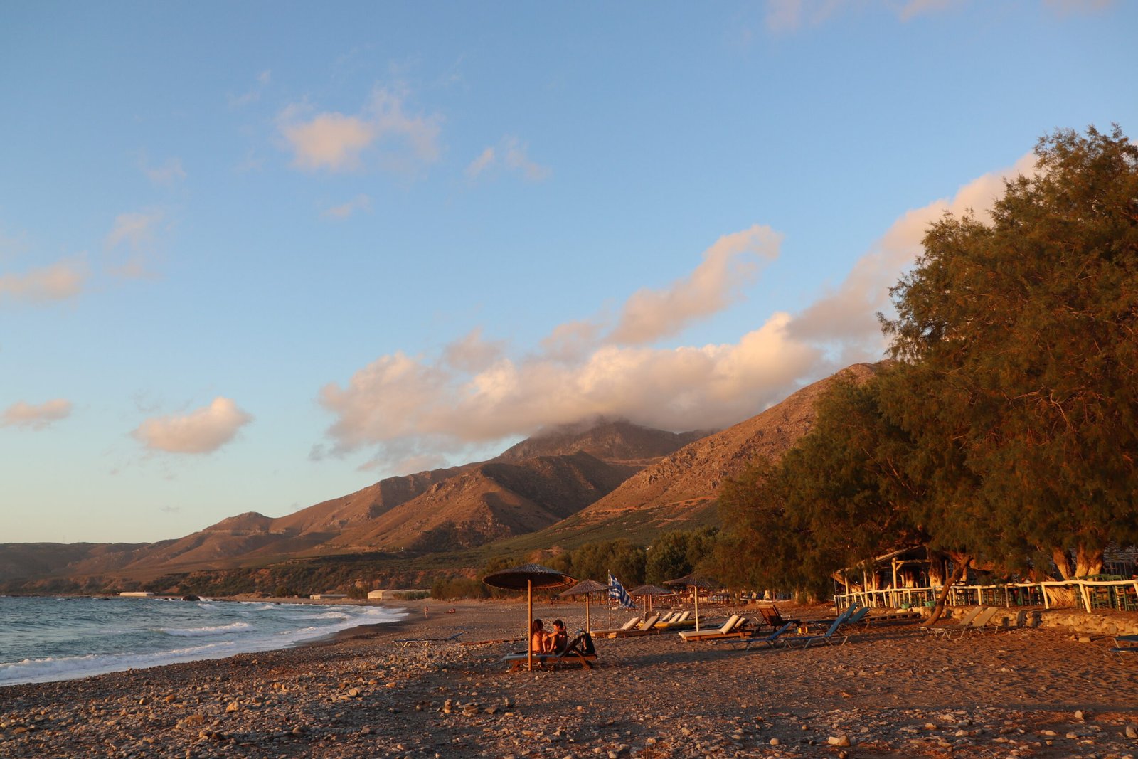 Sfinari Bay and Sunset Fish Restaurant sunbeds on the beach
