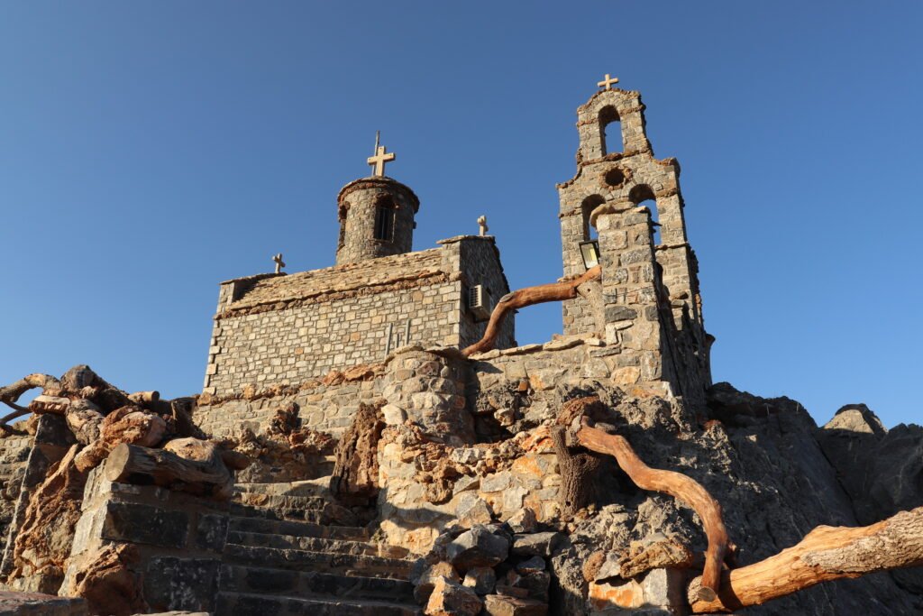 Agios Paisios Chapel close-up view of the stone walls and bell tower in Plakias Crete