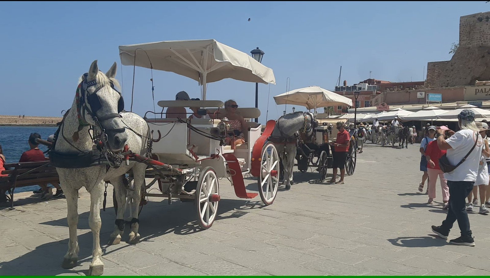 Horse carriages lined up like taxis at Chania Old Port