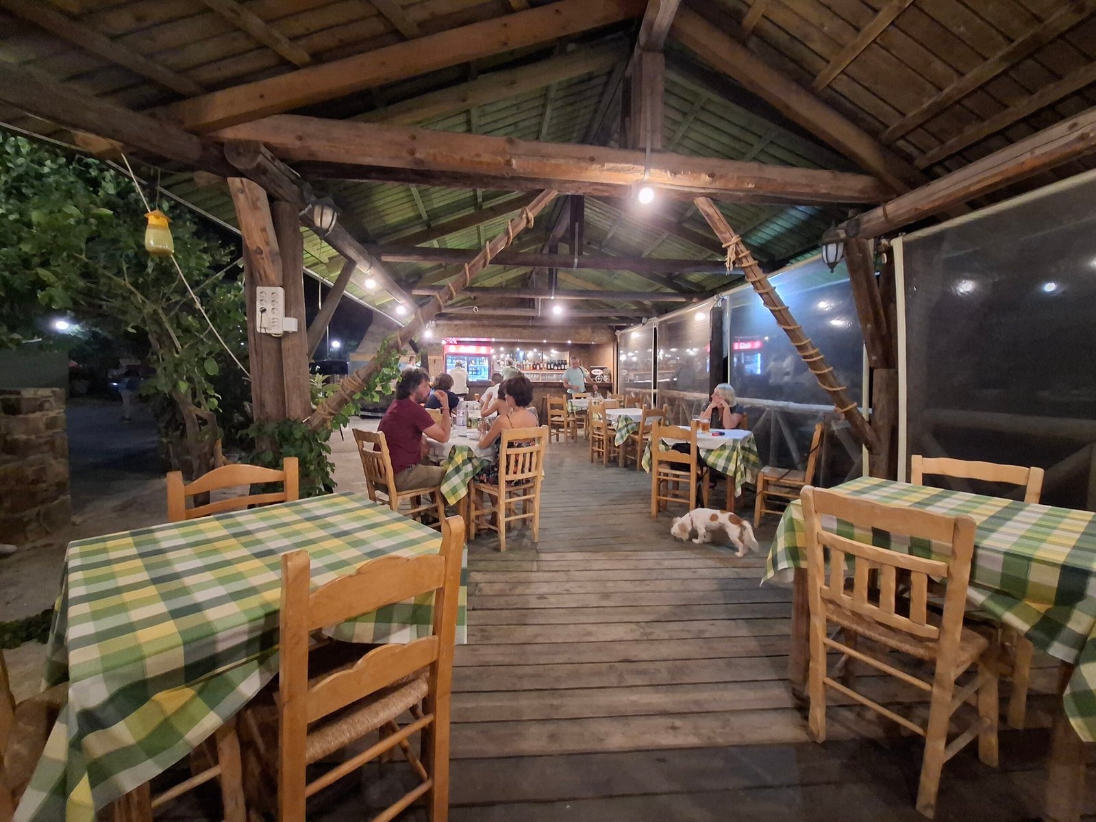 Warm wooden veranda at Lefteris Rooms & Tavern Wooden veranda of Lefteris Tavern with simple village tables