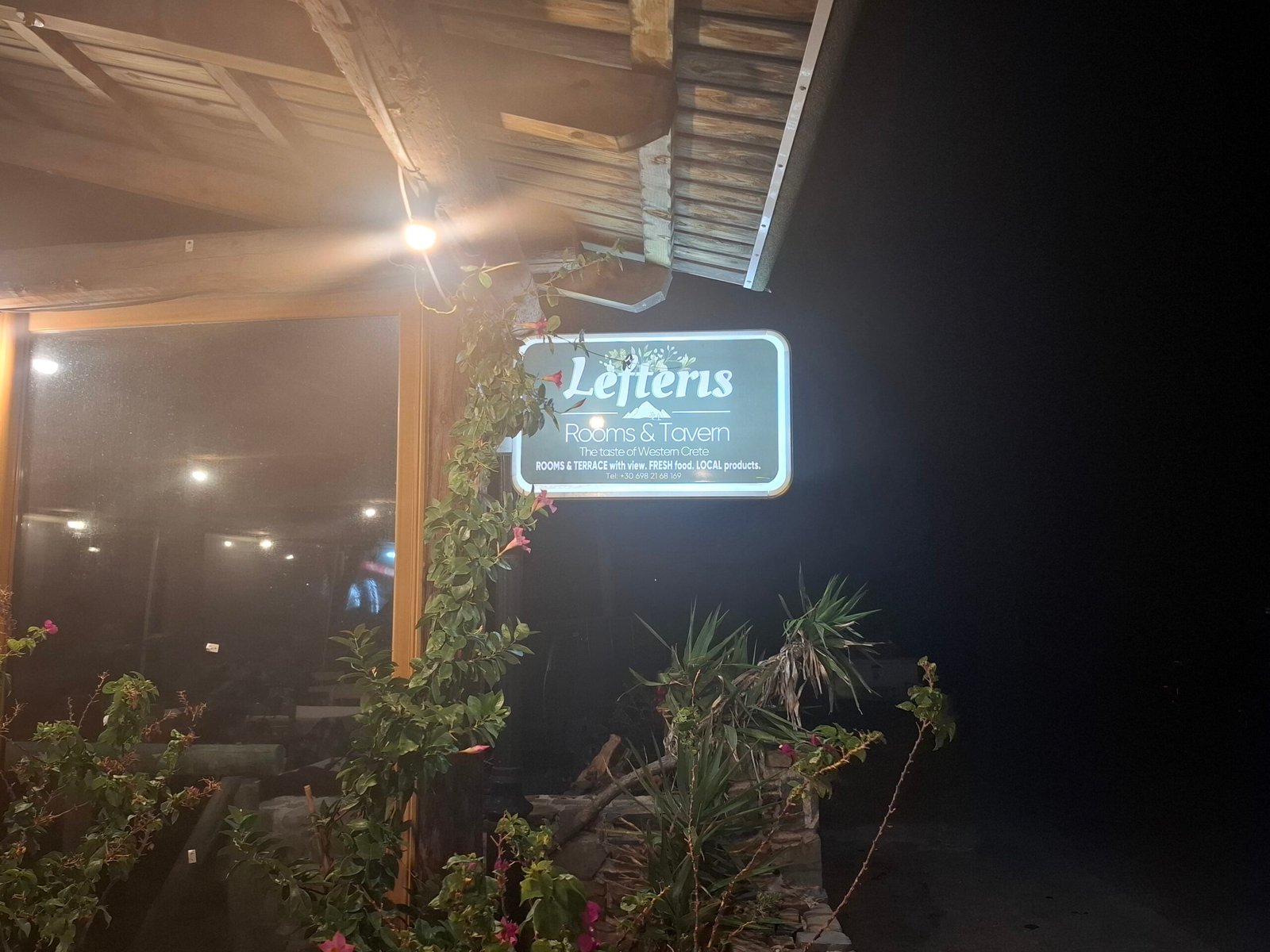 Lefteris Rooms & Tavern – traditional guesthouse and taverna in Kampos, West Crete Lefteris Rooms & Tavern sign at night in Kampos village