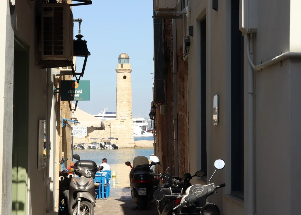 Narrow street with affordable taverns and cafés near the Venetian Lighthouse in Rethymno Old Town