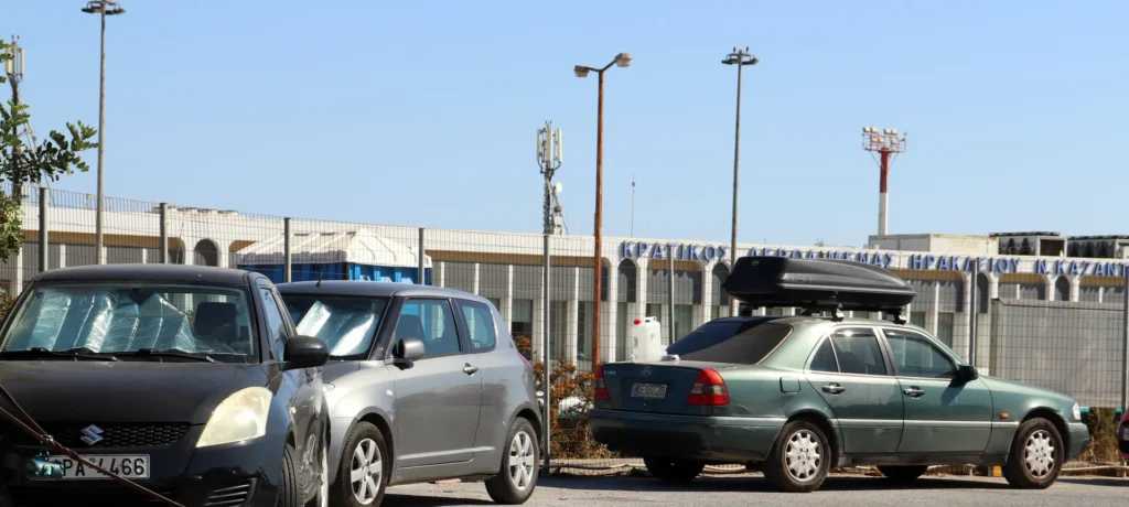 Cars parked near the terminal building at Heraklion Airport in Crete