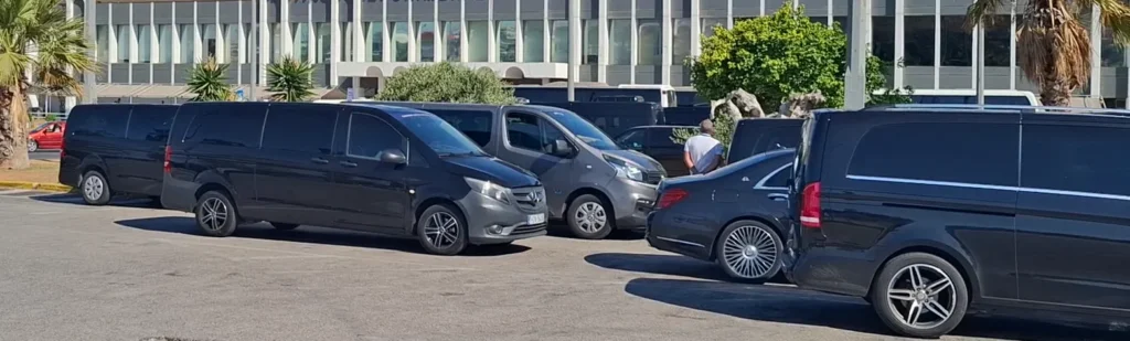 Private airport transfer vehicles waiting outside the terminal