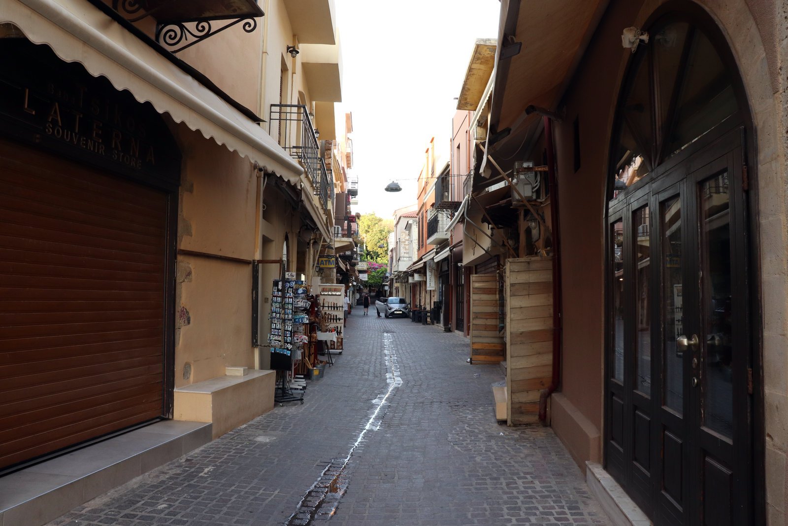 driving in Chania Old Town narrow street with car and scooter Crete
