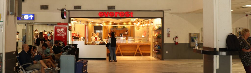 Passengers waiting near Everest café inside Heraklion Airport departures area