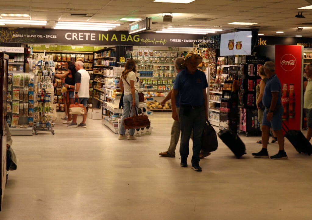 Travelers inside a Crete food and souvenir shop at Heraklion Airport