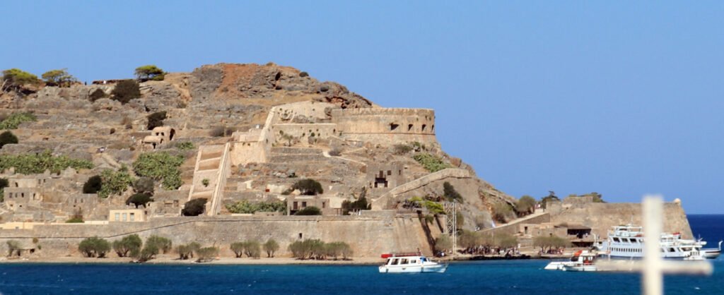 Historic fortress walls of Spinalonga Island in Crete during warm evening light