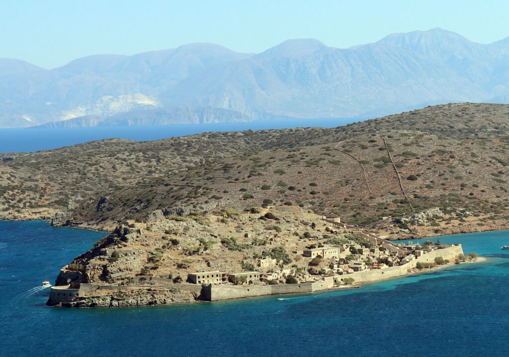 Aerial-style view of Spinalonga Island fortress in Crete surrounded by deep blue sea