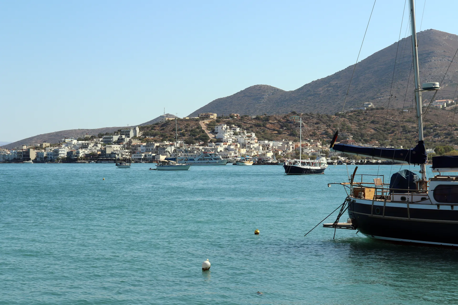 Elounda harbour with boats and hillside buildings on Crete