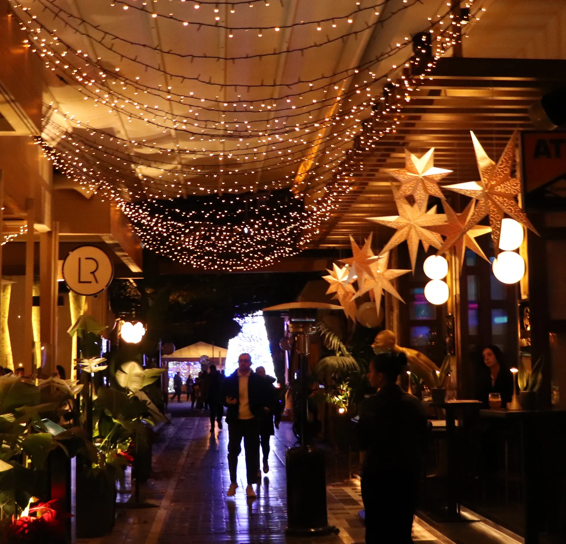 People walking through Rethymno Old Town at night in December