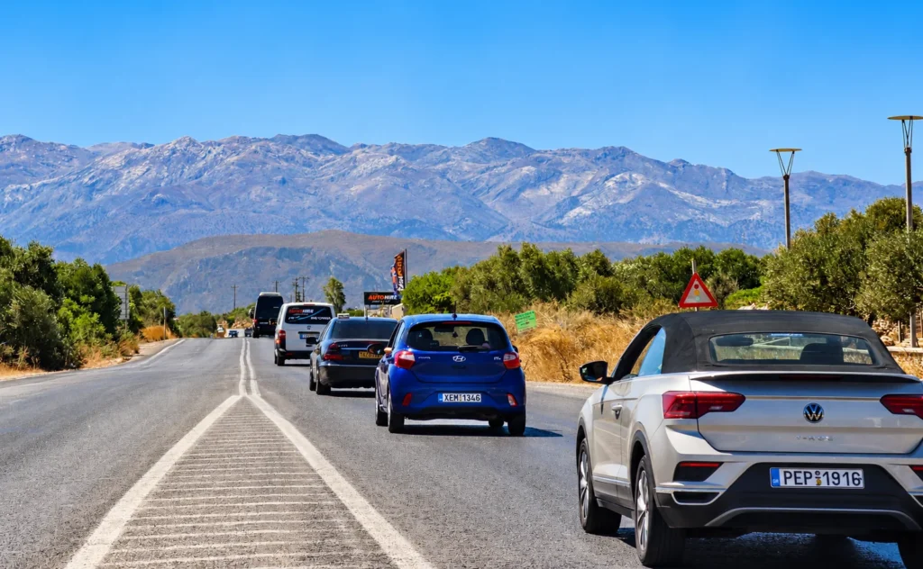 Traffic on a main road in Crete with the White Mountains in the background